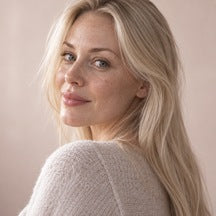 Woman using NAERVIA NAD+ firming serum